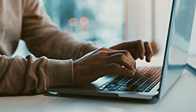 fingers typing on a keyboard